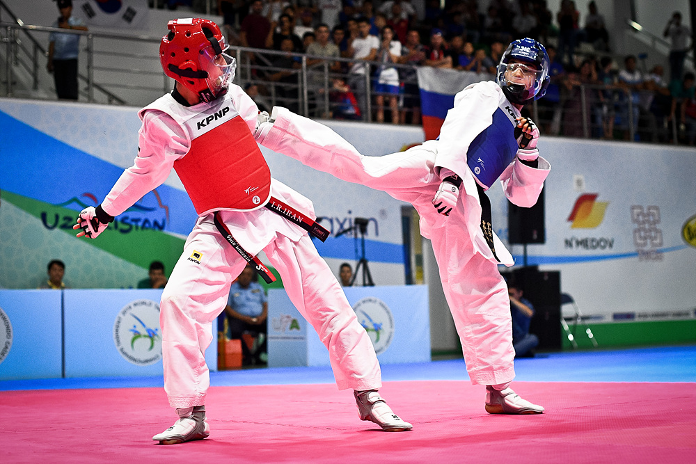 KARIMOV Zafarbek (UZB, right) attacks at the final of M-41kg